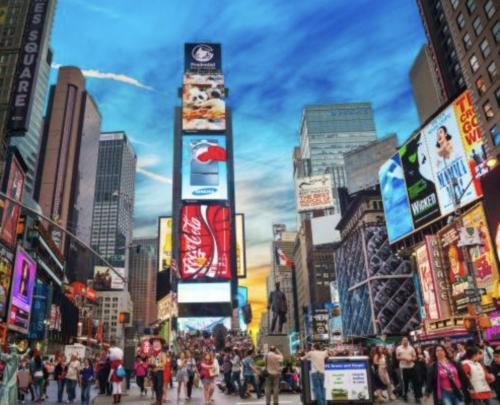 a crowd of people walking down a busy city street at Steps from Times Square - Cozy Room - Shared Bath in New York