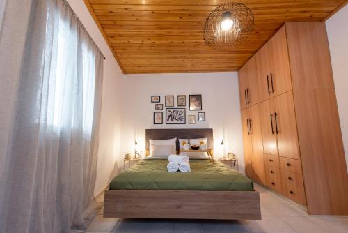 a bedroom with a bed and a large window at Αυλή στην Μαρίνα in Kalamata