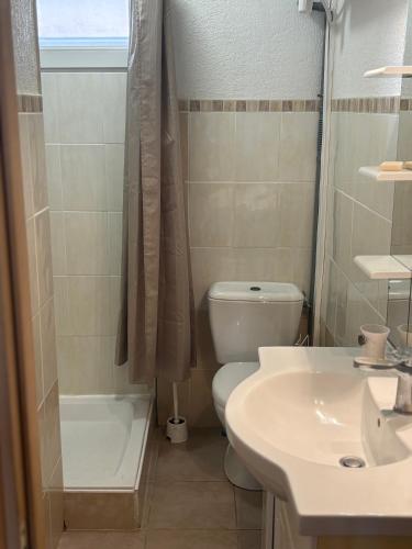 a bathroom with a toilet and a sink and a shower at La maisonnette LMV in Sanary-sur-Mer