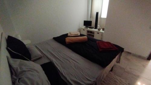 a bedroom with a bed and a television in it at Casa Pape e Toni in El Cotillo