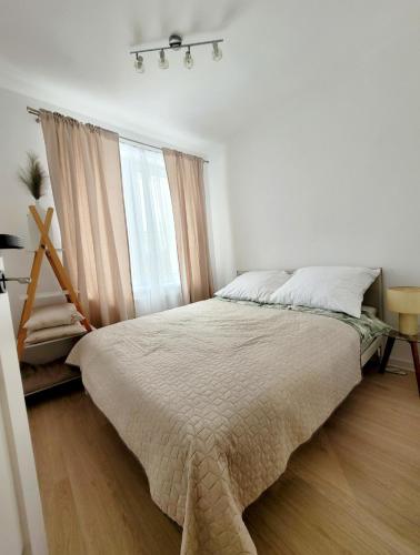 a bedroom with a large bed and a window at Przystanek Sudety in Wałbrzych