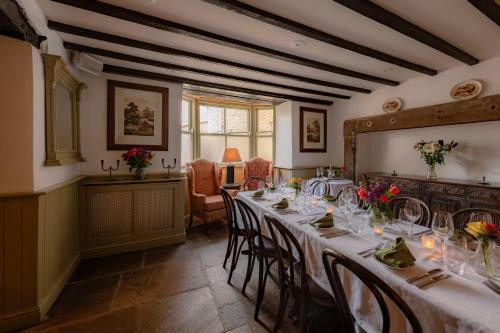 a dining room with a long table and chairs at The Wensleydale Hotel in Middleham