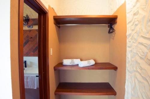 a bathroom with two towels sitting on a wooden shelf at Villa Germana in Paipa