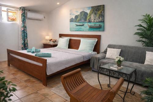 a living room with a bed and a couch at La Baraka in Dzaoudzi
