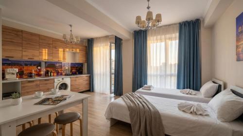 a hotel room with two beds and a kitchen at Cozy Almaty Escape in Almaty