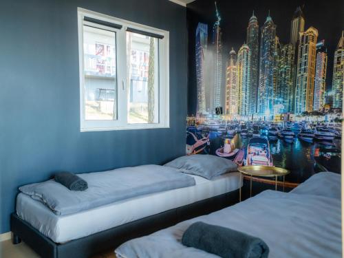 a room with two beds and a mural of a city at Perła Turawa in Turawa