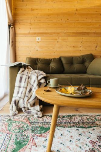 a living room with a table with a plate of food at Ritopia Glamping in Kovilj