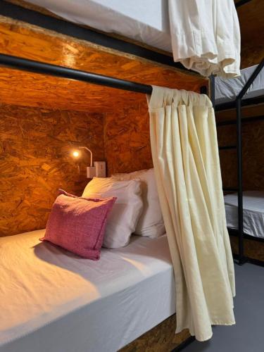a bed in a room with two bunk beds at The Boat House Cancun in Cancún