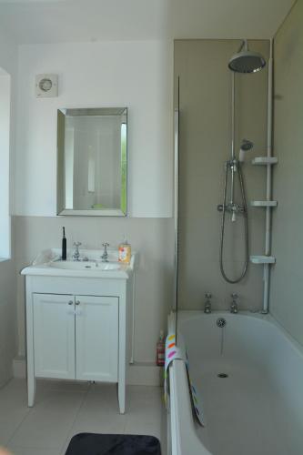 a bathroom with a sink and a tub and a shower at Peaceful Room Overlooking Nature & Parking in Bloxwich