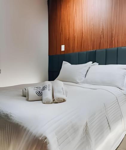 a large white bed with two pillows on it at Lapa Enredo in Rio de Janeiro