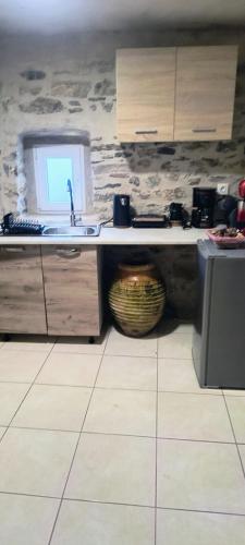 a kitchen with a sink and a counter top at Pyrgos Mitsakou in Vathia