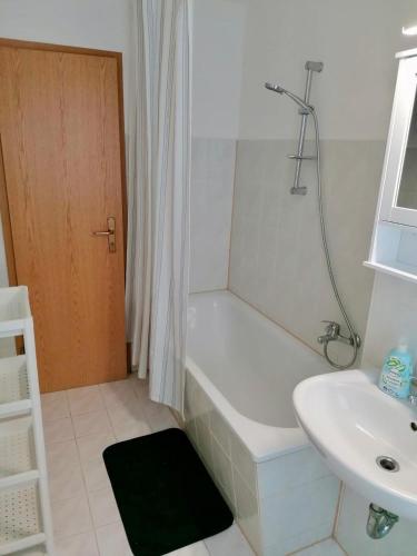a bathroom with a bath tub and a sink at Ferien- und Monteurwohnung in Borna Nr 5 in Borna