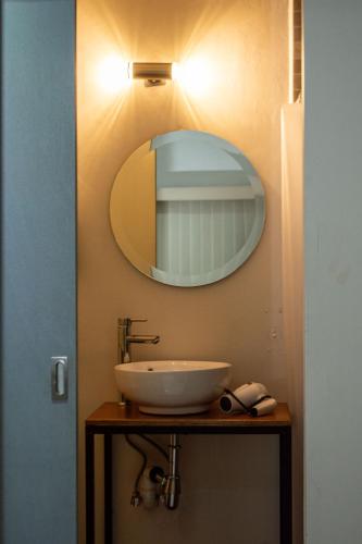 a bathroom with a sink and a mirror at Casa Nieto in Teotitlán del Camino