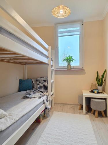 a bedroom with a bunk bed and a window at GreatHome Apartament in Zator