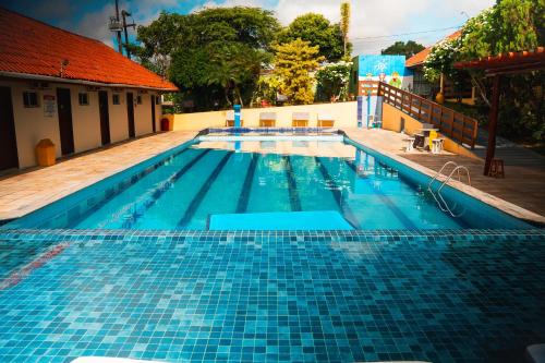 a large swimming pool with blue tiles on it at Pousada Granville in Campina Grande