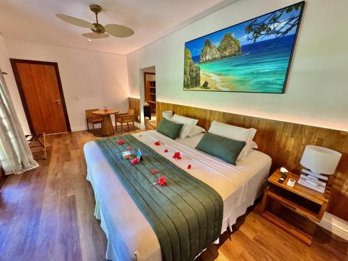 a bedroom with a large bed with flowers on it at Pousada do Vale in Fernando de Noronha