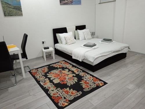 a bedroom with a bed with a rug on the floor at Studio apartman Sokak in Bihać