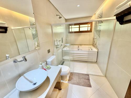 a bathroom with a sink and a toilet and a shower at Pousada do Vale in Fernando de Noronha