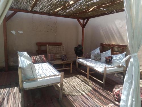 a living room with two chairs and a table at Villa Dar Daraa with Pool in Najem