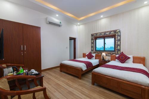 a hotel room with two beds and a window at Luxury Airport Hotel Travel in Sóc Sơn