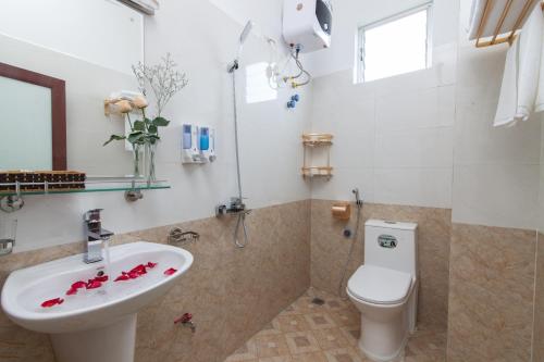 a bathroom with a sink and a toilet at Luxury Airport Hotel Travel in Sóc Sơn