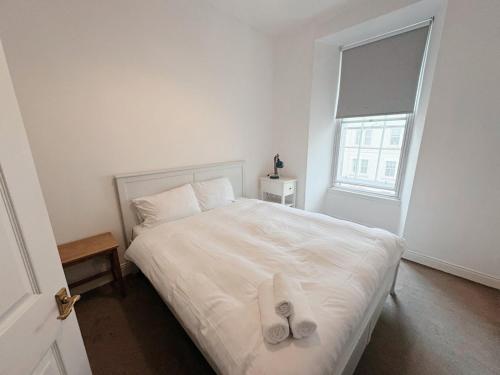 a bedroom with a bed with two towels on it at Edinburgh Town Apartment in Edinburgh
