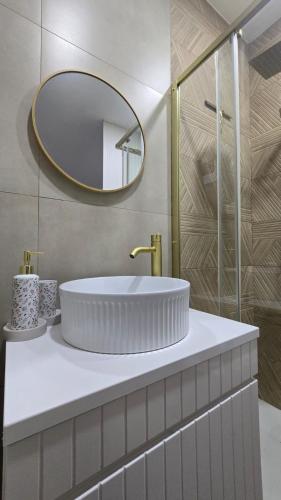 a bathroom with a white sink and a mirror at Malu in Pinhal do Douro