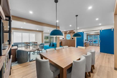 a dining room and living room with a table and chairs at Everhome Suites Somerset - South Brunswick by Choice Hotels in Somerset