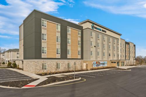 an exterior rendering of a building with a parking lot at Everhome Suites Somerset - South Brunswick by Choice Hotels in Somerset