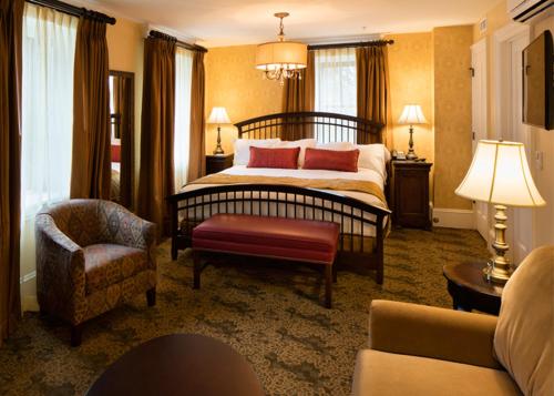 a hotel room with a bed and a chair at The Washington House Hotel & Restaurant in Sellersville