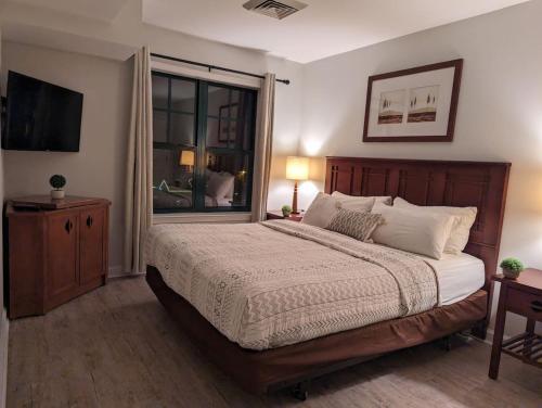 a bedroom with a large bed and a window at Premium New 1bd Sunset balcony 3rd flr in Vernon Township