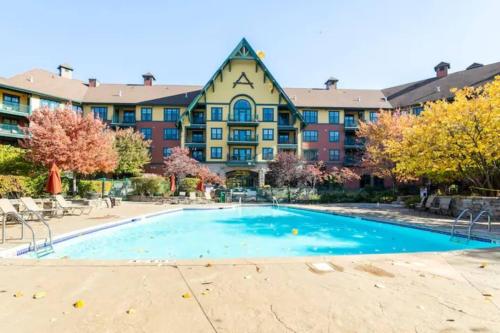 a swimming pool in front of a building at Renovated Chic Premium 1 bdrm in Vernon Township