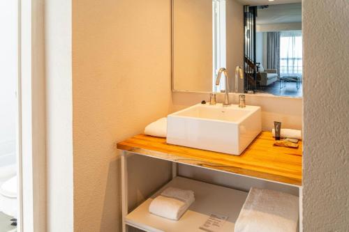 a bathroom with a sink and a mirror at City Express Plus by Marriott Buenos Aires Palermo in Buenos Aires