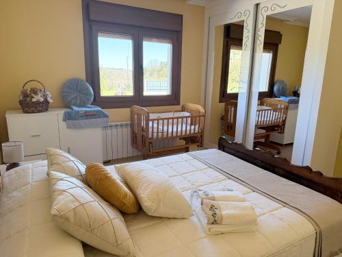 a bedroom with a large bed and a mirror at Refugio y Calma in Chantada