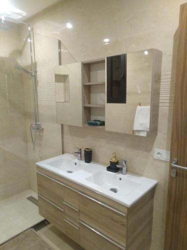 a bathroom with a white sink and a shower at Villa Dar Daraa with Pool in Najem