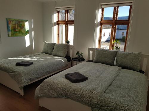 a bedroom with two beds and a window at STAY Billund in Vandel