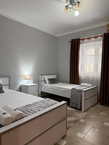 a bedroom with two beds and a window at Shiroke Relax Villa in Shirokë
