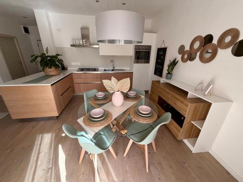 a kitchen with a table and chairs in a kitchen at Al Nio in Baselga di Pinè