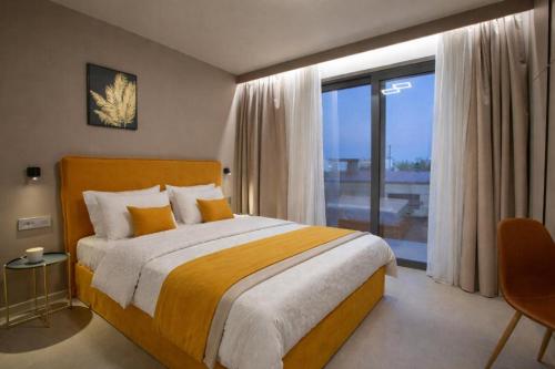 a bedroom with a large bed and a large window at Elysian Luxury Suite in Preveza