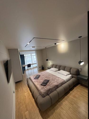 a bedroom with a large bed in a room at Перлина Франківська in Ivano-Frankivsk