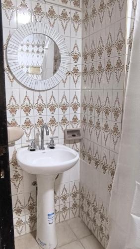 a bathroom with a sink and a mirror at Monoambientes Peatonal - con cochera in Corrientes