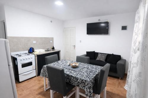 a kitchen and a living room with a table and a couch at Departamentos Turísticos Cloe 2 in Fiambalá