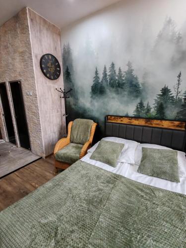 a bedroom with a bed and a clock and a chair at W pięknej KAMIENICY in Wałbrzych