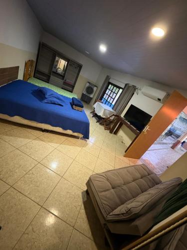 a bedroom with a bed and a couch in it at Pouso amigo do Vt 2 in Paracambi
