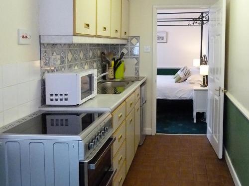 a small kitchen with a sink and a microwave at Juniper - 28060 in Wheddon Cross