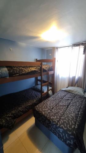 a bedroom with two bunk beds and a window at Dpto full amoblado en copiapo 4 in Copiapó
