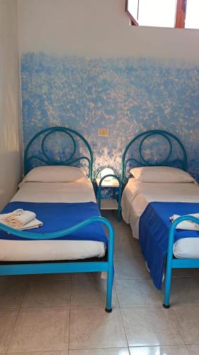 two beds sitting next to each other in a room at Villa Petrusa in Stromboli