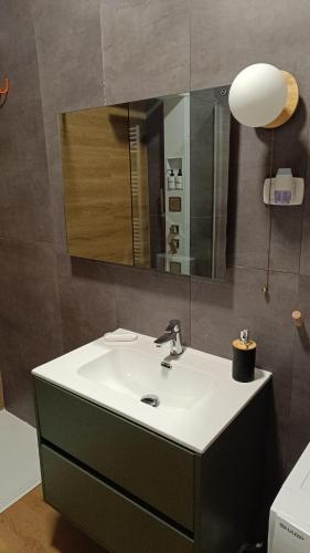 a bathroom with a sink and a mirror at RC vacanze interno 57 in Rocca di Mezzo
