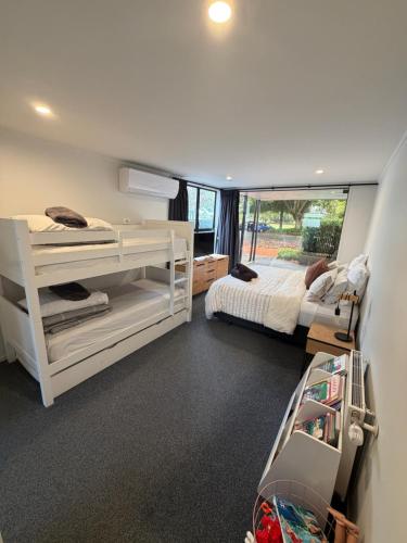 a bedroom with two bunk beds and a bed at T Two on Whakaue in Rotorua