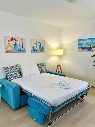 a bed with a blue bed frame in a room at Antico Borgo San Zeno in Bardolino